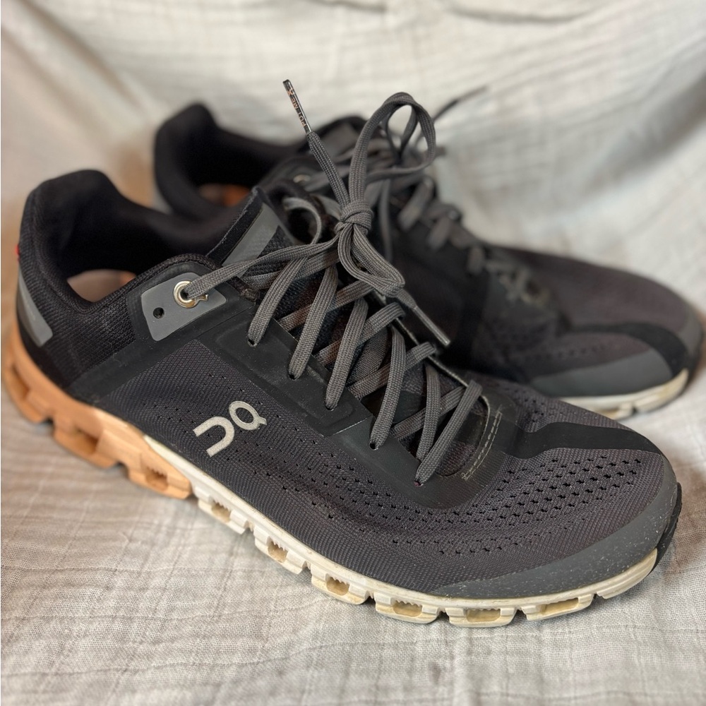 On Running Black and Tan Athletic Shoes with Cloud Cushioning